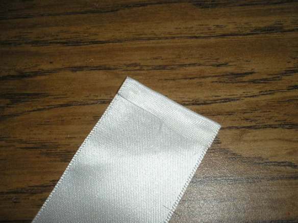Glue over a small "hem" on each end of your ribbon. This gives you a finished look and prevents your ribbon from fraying