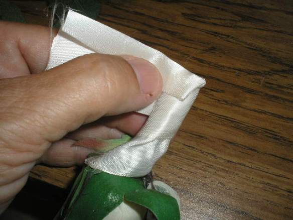 When your open end is about 1/2 - 3/4 in below the end of your stems, glue and fold it back up onto the stem. Continue wrapping and gluing remaining ribbon, around end of stem.